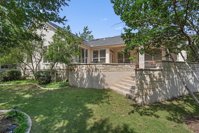 259 Red Poppy Trl, Georgetown, TX 78633 - rear view of house with a lawn, stairway, stucco siding, and stone siding