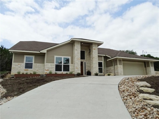 20601 Branding Iron, Lago Vista, TX 78645 - view of front of house featuring stone siding, concrete driveway, a garage, and a shingled roof