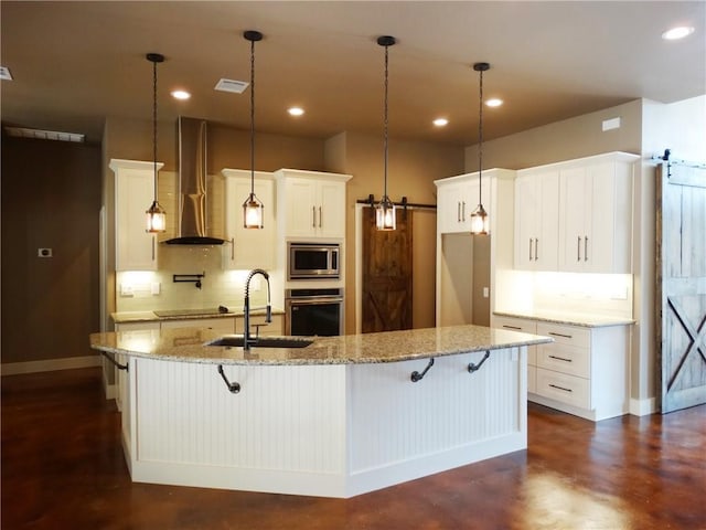 20601 Branding Iron, Lago Vista, TX 78645 - kitchen featuring wall chimney range hood, stainless steel appliances, tasteful backsplash, a sink, and recessed lighting