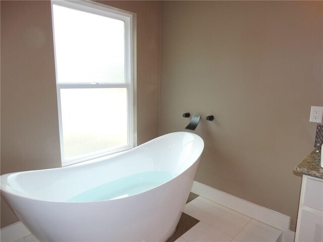 20601 Branding Iron, Lago Vista, TX 78645 - full bathroom featuring a freestanding bath, vanity, and baseboards