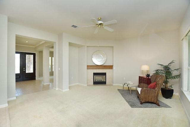 115 Blazing Star Dr, Georgetown, TX 78633 - living area featuring carpet flooring, a ceiling fan, baseboards, a tile fireplace, and ornamental molding