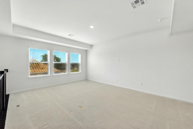 spare room featuring carpet and baseboards