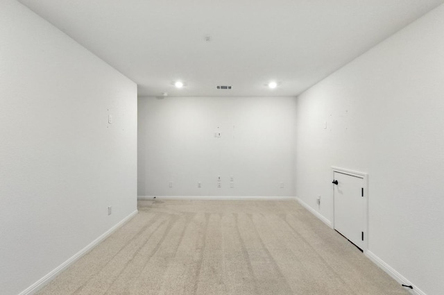 unfurnished room featuring recessed lighting, light colored carpet, and baseboards