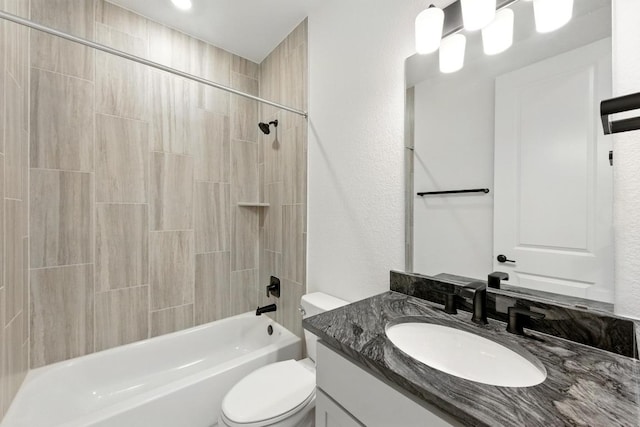 bathroom featuring toilet, vanity, and shower / bathtub combination