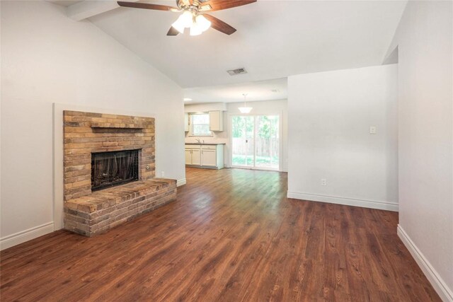 16213 Malden Dr, Pflugerville, TX 78660 - unfurnished living room featuring ceiling fan, dark wood-style floors, and a brick fireplace