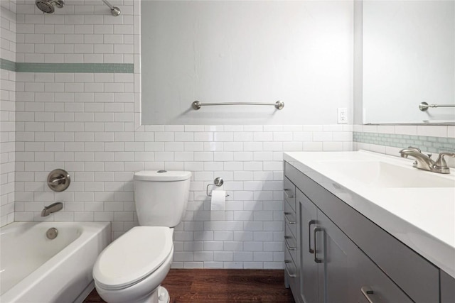 16213 Malden Dr, Pflugerville, TX 78660 - full bath featuring vanity, tile walls, wood finished floors, and bathtub / shower combination