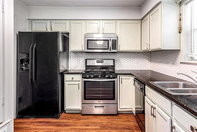 16213 Malden Dr, Pflugerville, TX 78660 - kitchen featuring black appliances, dark wood-type flooring, and decorative backsplash