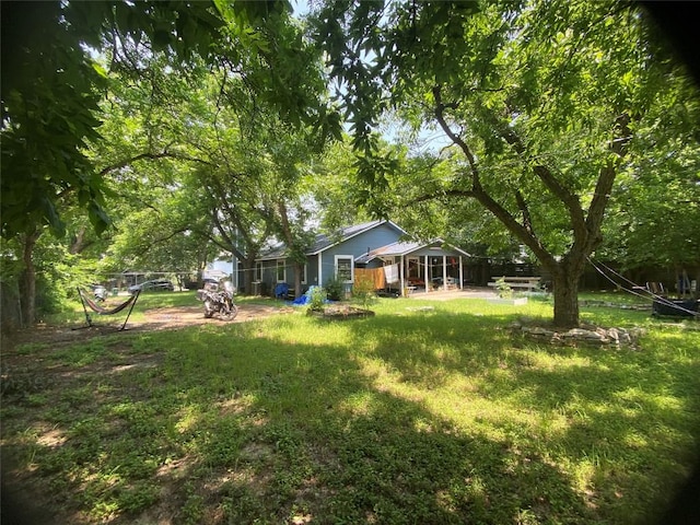 view of green lawn featuring a patio area