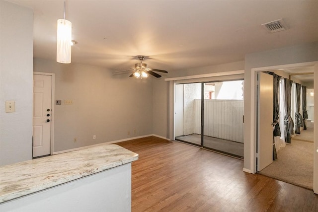 3115 Helms St Unit 115, Austin, TX 78705 - unfurnished living room featuring a ceiling fan and wood finished floors