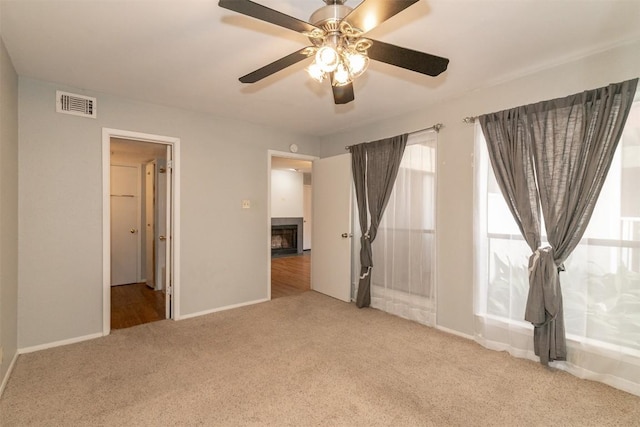 3115 Helms St Unit 115, Austin, TX 78705 - unfurnished bedroom with carpet floors, a fireplace, and ceiling fan
