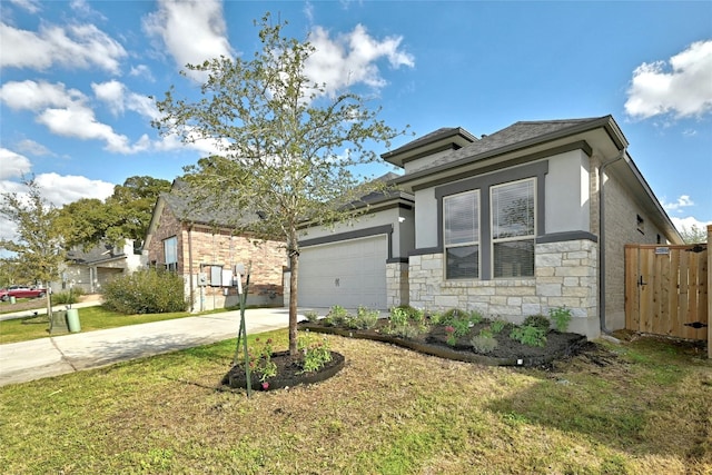 12725 Bloomington Dr Unit 129, Austin, TX 78748 - view of front of home with concrete driveway, an attached garage, stone siding, and stucco siding