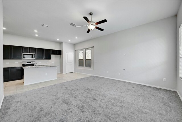 12725 Bloomington Dr Unit 129, Austin, TX 78748 - unfurnished living room with ceiling fan, light colored carpet, baseboards, recessed lighting, and light tile patterned floors