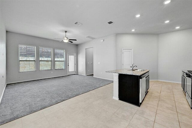 12725 Bloomington Dr Unit 129, Austin, TX 78748 - kitchen with light colored carpet, recessed lighting, a ceiling fan, stainless steel dishwasher, and baseboards