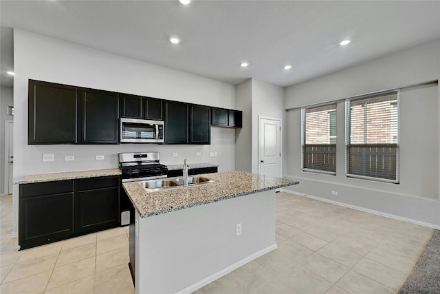 12725 Bloomington Dr Unit 129, Austin, TX 78748 - kitchen featuring stainless steel appliances, a sink, dark cabinets, light tile patterned floors, and recessed lighting