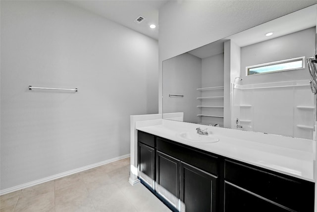 12725 Bloomington Dr Unit 129, Austin, TX 78748 - bathroom featuring baseboards, vanity, recessed lighting, and a shower