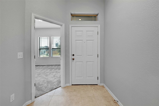 12725 Bloomington Dr Unit 129, Austin, TX 78748 - foyer entrance with baseboards, light tile patterned floors, and light carpet