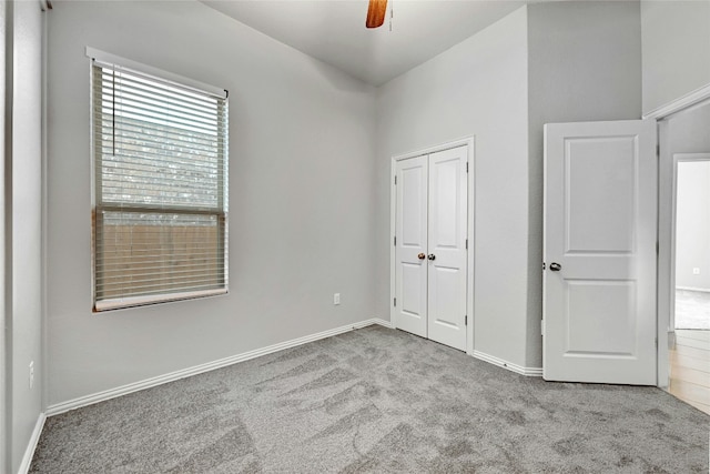 12725 Bloomington Dr Unit 129, Austin, TX 78748 - unfurnished bedroom featuring carpet flooring, a closet, baseboards, and a ceiling fan