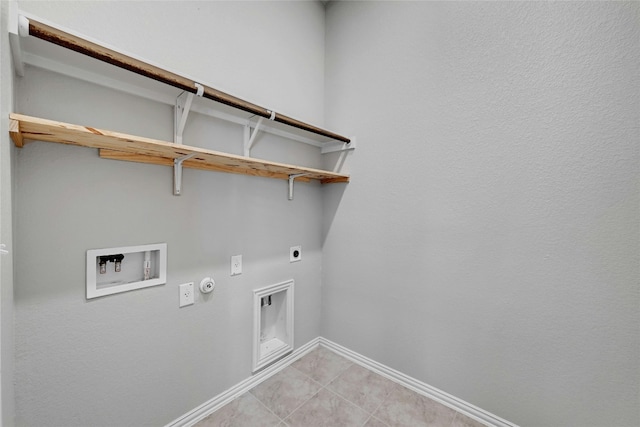 12725 Bloomington Dr Unit 129, Austin, TX 78748 - washroom with electric dryer hookup, gas dryer hookup, hookup for a washing machine, baseboards, and light tile patterned flooring