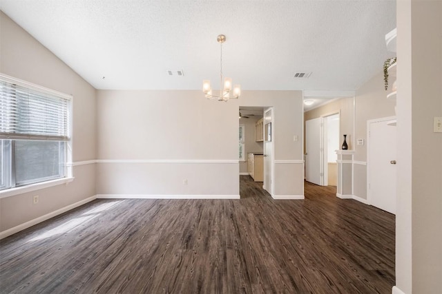 7503 Islander Dr, Austin, TX 78749 - empty room featuring a chandelier, dark wood-style floors, baseboards, and lofted ceiling