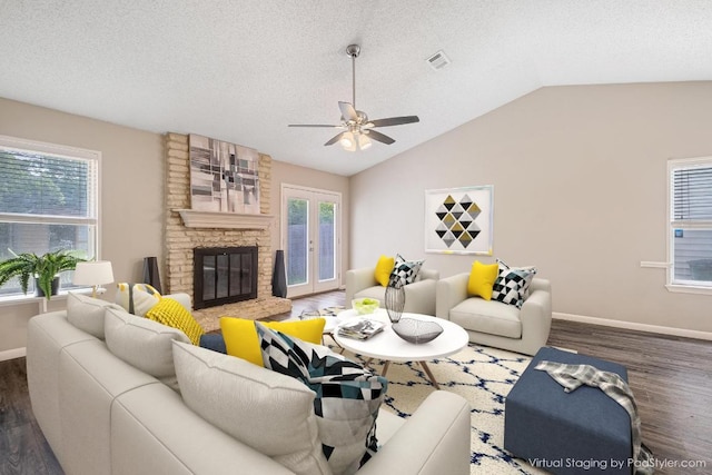 7503 Islander Dr, Austin, TX 78749 - living room with wood finished floors, lofted ceiling, ceiling fan, baseboards, and a fireplace