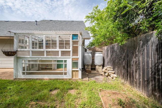 7503 Islander Dr, Austin, TX 78749 - back of house featuring roof with shingles and fence