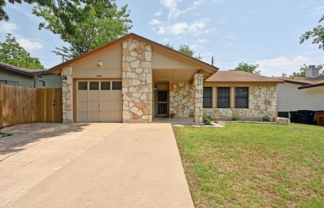 mid-century inspired home with stone siding, an attached garage, and driveway