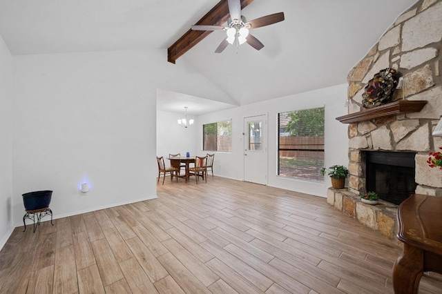 5406 Fence Row, Austin, TX 78744 - living area featuring wood finished floors, a stone fireplace, a ceiling fan, a chandelier, and baseboards