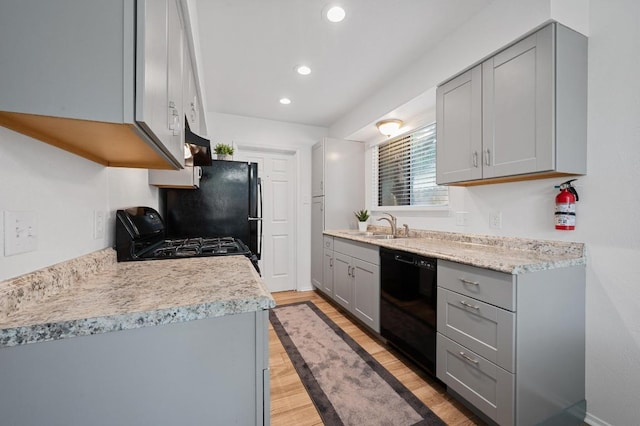 5406 Fence Row, Austin, TX 78744 - kitchen with dishwasher, gray cabinets, gas range oven, recessed lighting, and light countertops
