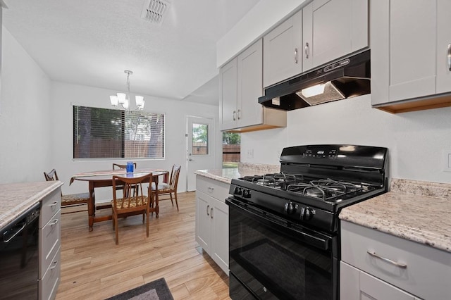 5406 Fence Row, Austin, TX 78744 - kitchen featuring black appliances, under cabinet range hood, light wood-style flooring, a chandelier, and decorative light fixtures