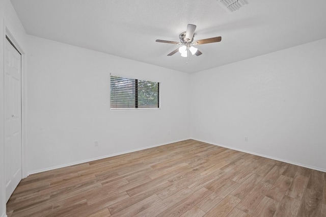 5406 Fence Row, Austin, TX 78744 - spare room featuring a ceiling fan, light wood-style floors, and baseboards