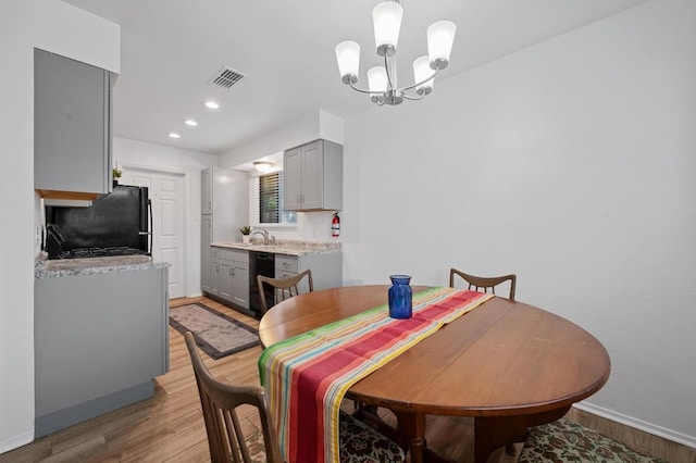 5406 Fence Row, Austin, TX 78744 - dining area with light wood-style floors, baseboards, a chandelier, and recessed lighting