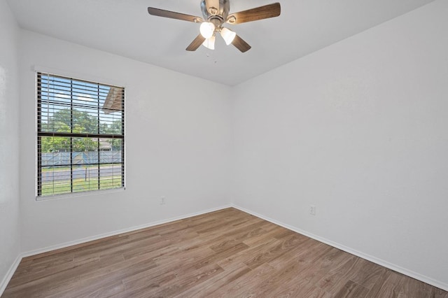 spare room with light wood-style floors, baseboards, and ceiling fan