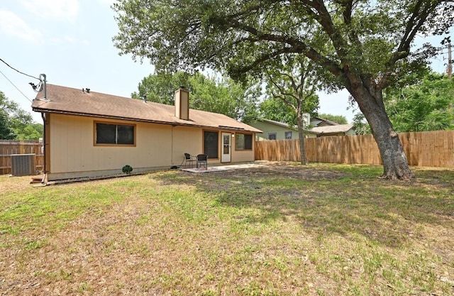 rear view of house featuring a chimney and a patio area