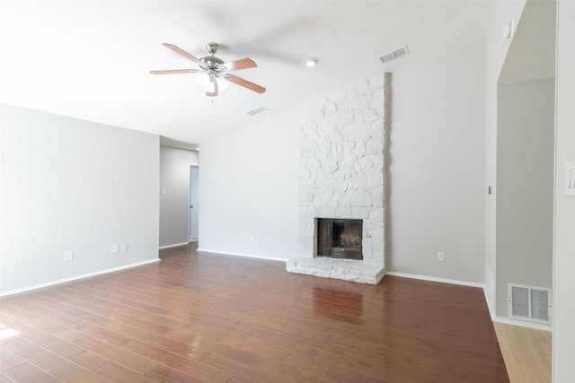 12602 Pluto Ln, Austin, TX 78727 - unfurnished living room featuring a ceiling fan, wood finished floors, a fireplace, and vaulted ceiling