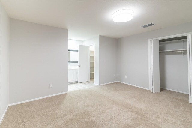 12602 Pluto Ln, Austin, TX 78727 - unfurnished bedroom featuring light colored carpet and a closet