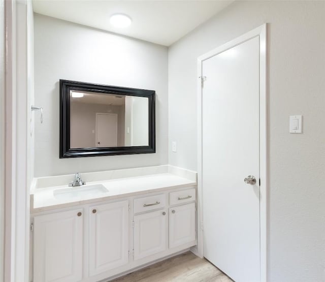 12602 Pluto Ln, Austin, TX 78727 - bathroom with vanity and wood finished floors