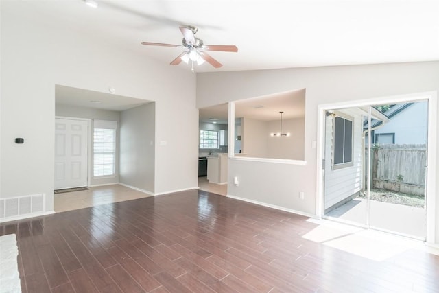 12602 Pluto Ln, Austin, TX 78727 - unfurnished living room with lofted ceiling, wood finished floors, and ceiling fan