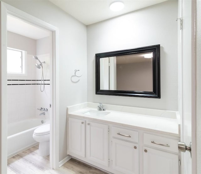 12602 Pluto Ln, Austin, TX 78727 - full bathroom featuring vanity, wood finished floors, and shower / bathtub combination