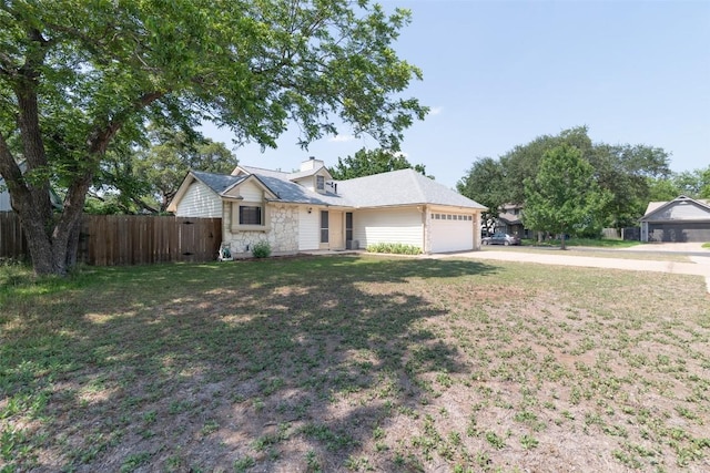 12602 Pluto Ln, Austin, TX 78727 - view of front of home featuring concrete driveway, a garage, and stone siding