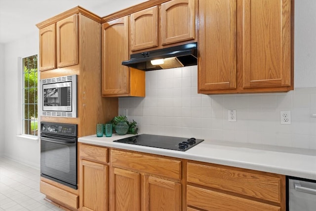 106 Ranch House Cv, Georgetown, TX 78633 - kitchen featuring black appliances, under cabinet range hood, light countertops, and backsplash