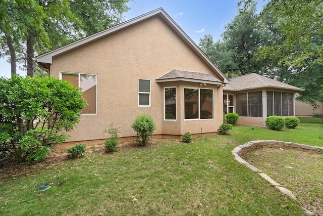 106 Ranch House Cv, Georgetown, TX 78633 - rear view of property featuring stucco siding, a yard, and a sunroom