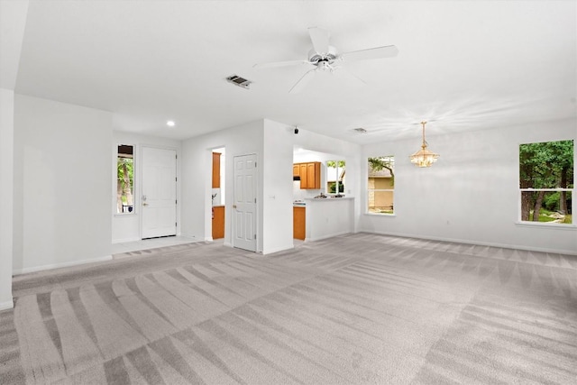 106 Ranch House Cv, Georgetown, TX 78633 - unfurnished living room with light colored carpet, a chandelier, baseboards, a ceiling fan, and recessed lighting