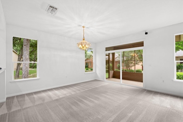 106 Ranch House Cv, Georgetown, TX 78633 - spare room with carpet floors, plenty of natural light, and a chandelier