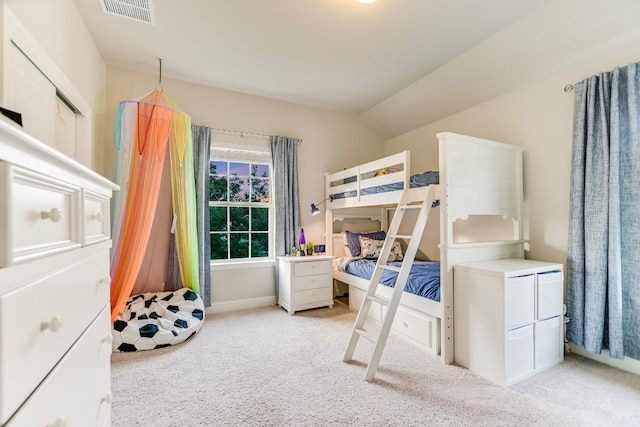 bedroom with light carpet, vaulted ceiling, and baseboards