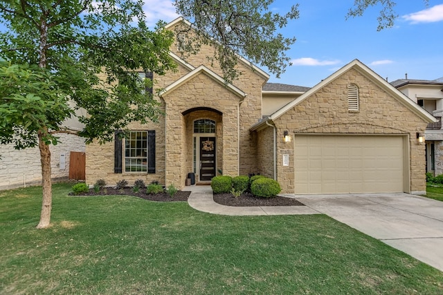 view of front of home with driveway, a garage, a front yard, and stone siding
