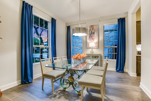 dining area featuring wood finished floors and baseboards