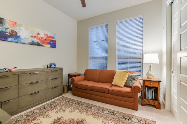 living room featuring light carpet and ceiling fan