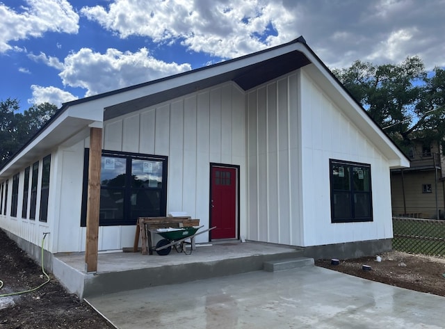 1127 Greenhill Dr, Canyon Lake, TX 78133 - rear view of house with fence and board and batten siding