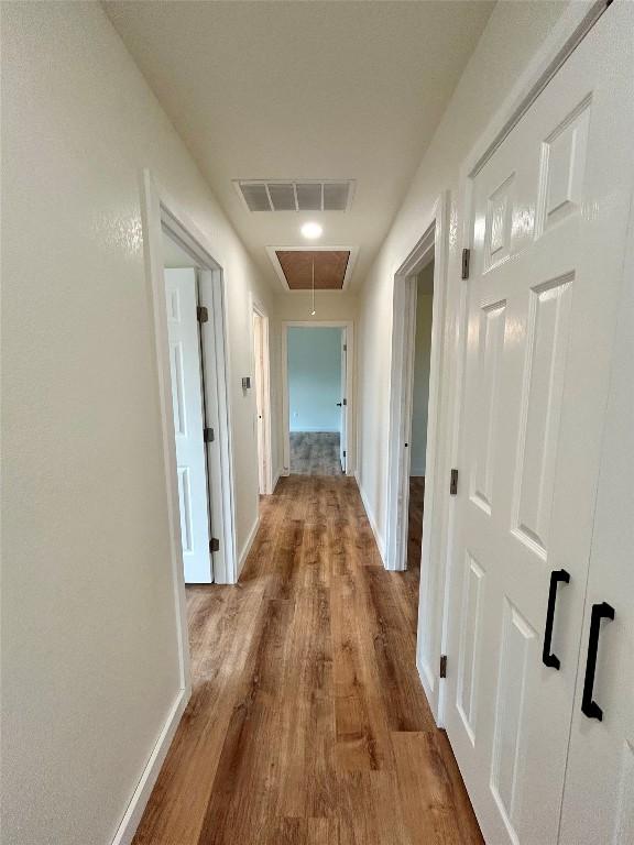 1127 Greenhill Dr, Canyon Lake, TX 78133 - hall with attic access and wood finished floors