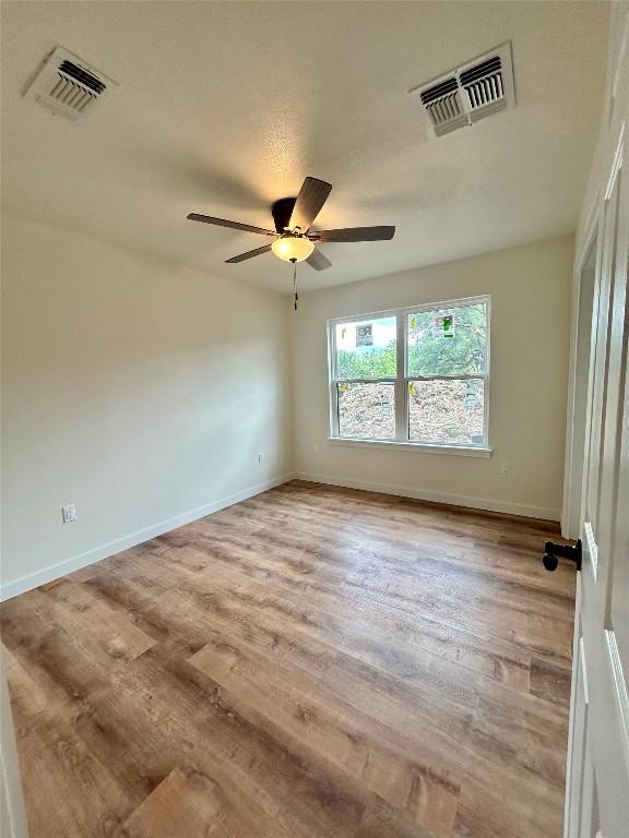 1127 Greenhill Dr, Canyon Lake, TX 78133 - empty room featuring a ceiling fan and light wood finished floors